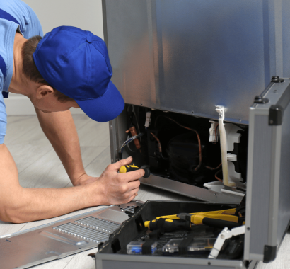 male-technician-fixing-freezer-kitchen